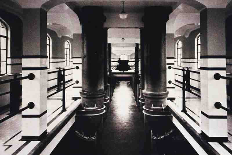 The interior view of the water plant with double cylinders. The water channel with two degrees of depth of field, the corridors on both sides to monitor the production and the characteristic small windows in the corridors are all very impressive